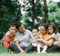 happy family sitting on grass