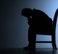 man slumped with head in hands