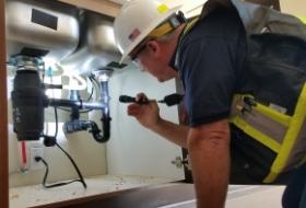 inspector is inspecting plumbing