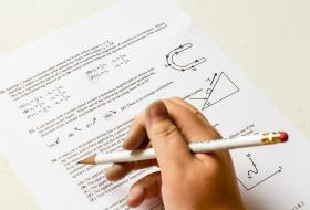 test paper with hand holding pencil