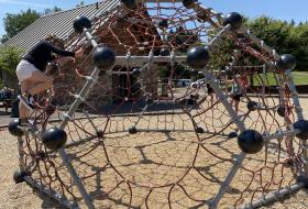 girl climbing on play equipment