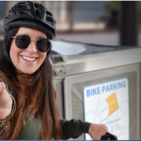 Female holding bike link card