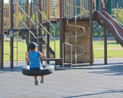 child on tire swing