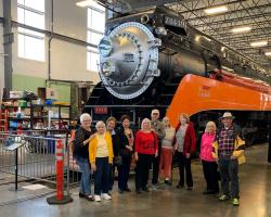 group in front of train