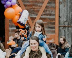 child on moms shoulders
