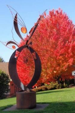Fall Butterfly Sculpture and Red Autumn Leaves Tree