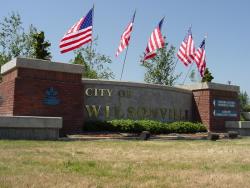 Wall with welcome sign and flags