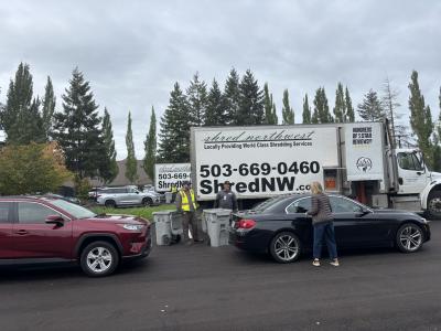 Cars pulling up to shredding truck