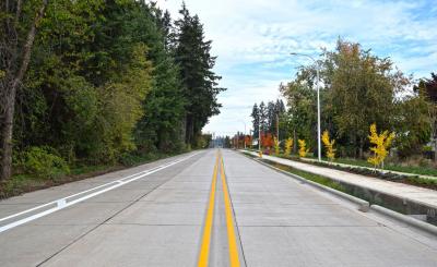 A new segment of Garden Acres Rd. includes a sidewalk offset from the roadway.