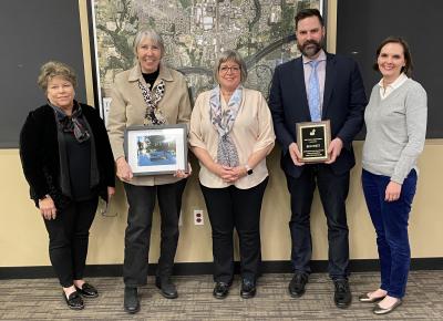 Councilors Lehan and West receiving plaques commemorating their service to Wilsonville. 