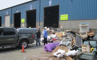 People removing mattress from flatbed