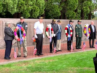 Veterans and dignitaries standing at the Oregon Korean War Memorial during 2022 ceremony on Veterans Day. 