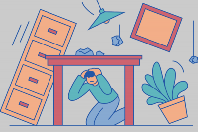 Graphic shows a person under a table during an earthquake