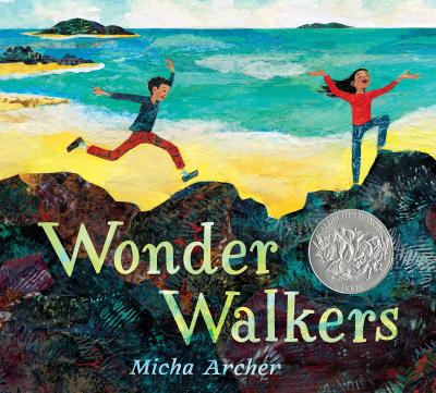 Two children run along a beach
