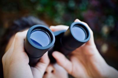person looking through binoculars