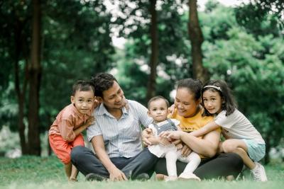 happy family sitting on grass