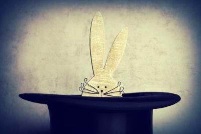 magician's hat with a paper rabbit  peeking out of it
