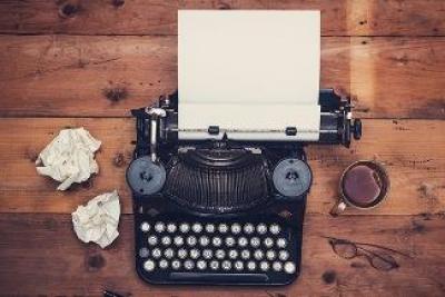 typewriter with crumpled sheets of paper