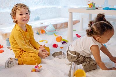 toddler boy and girl playing with blocks