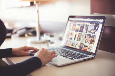 person with laptop showing photo images
