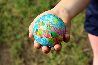 hand holding toy globe