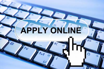 computer keyboard with hand pointer cursor pointing at text Apply Online