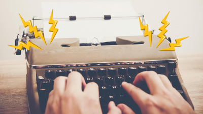 person typing on a typewriter