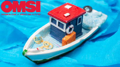 toy boat on blue torn paper water