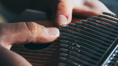 thumbs playing a kalimba