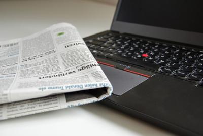newspaper with computer