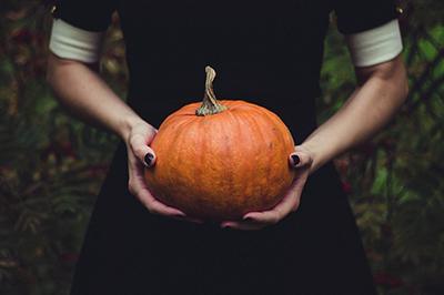 Pilgrim woman holding pumpkin