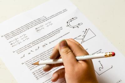 test paper with hand holding pencil