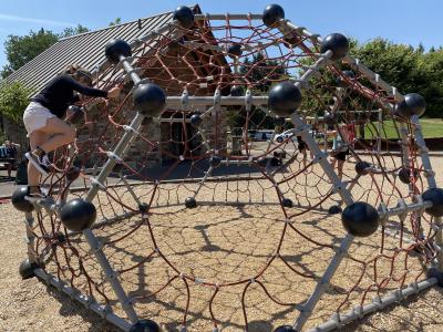 girl climbing on play equipment