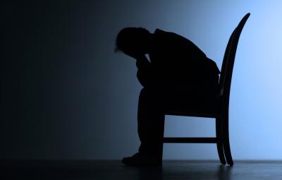 man slumped with head in hands