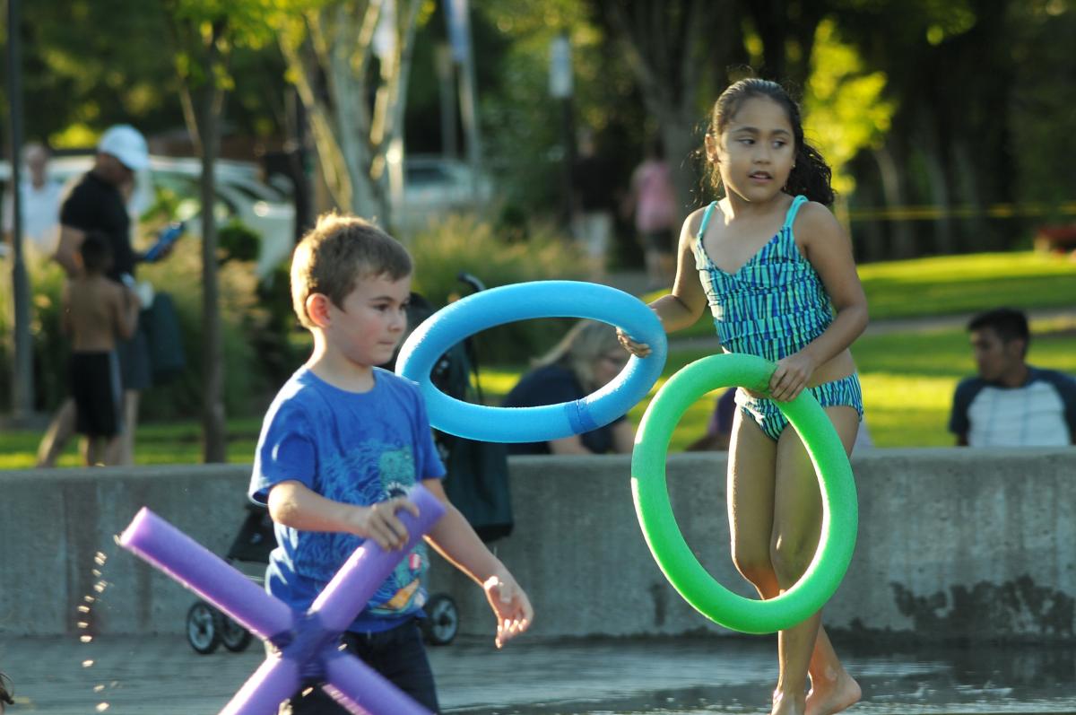 Games, including tic tac toe, are among the family-friendly activities at the Block Party. Kids playing with giant Tic Tac Toe pieces at community block party