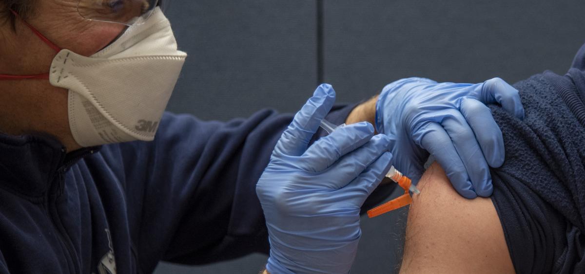 TVF&R Employee receives vaccination in shoulder