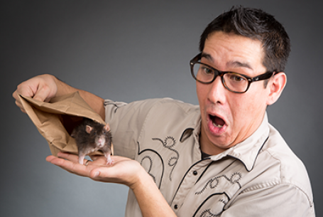 photo of Louie Foxx looking surprised while holding a paper bag with a mouse peeking out of it
