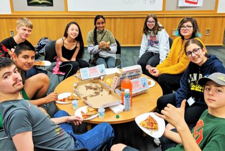 meeting of teens at a TAB meeting eating pizza