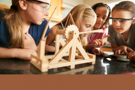 kids using a wooden catapult