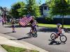 kids on bikes holding flag